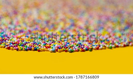 Background texture of multicolored foam balls.
Scattering of  bright foam balls