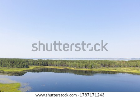 Aerial photo of forest boggy lake in the Karakansky pine forest near the shore of the Ob reservoir. Siberia, Russia