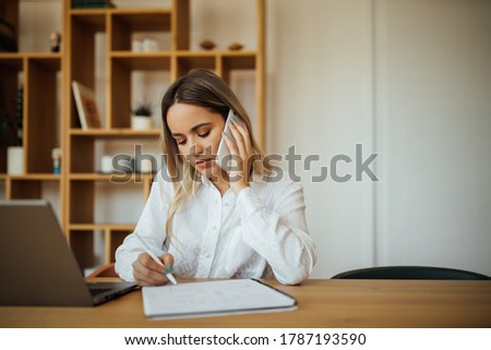 Young businesswoman working in home office, portrait.