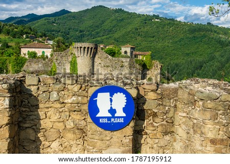 "Kiss...please" sign makes a perfect occasion for lovers for taking pictures with the beautiful fortress of Castiglione di Garfagnana in the background. The fortress was built in Middle Age.