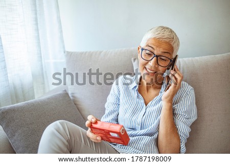 Senior Woman Talking on Smartphone with her Doctor to Inform about Medication Instructions. Elderly Woman Checking Medical Information While Using Mobile Phone