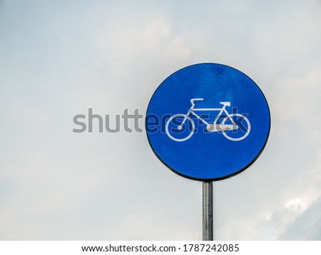 Street or road sign with a bicycle. Bicycle sign with cloudy sky as background.