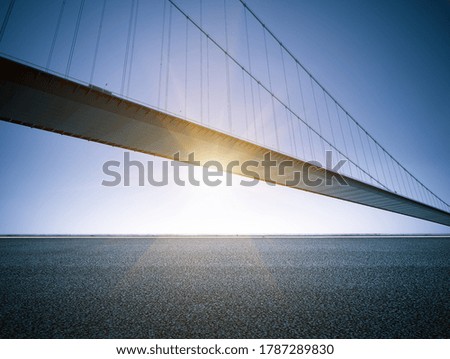  Asphalt road under a suspension bridge across the Yangtze River, China