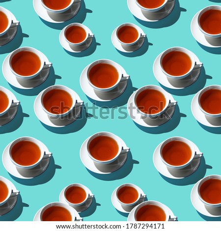 A pattern consisting of a white tea Cup and saucer on a blue background. There is a lot of empty space for the text. A concept for an ad or banner, and possibly a menu, as well as for a collage
