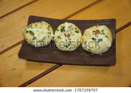 Viral and popular bread. Korean cream cheese garlic bread. Bread filled with cream cheese is poured with a garlic butter sauce made from a mixture, garlic, eggs, honey, dried parsley and butter.