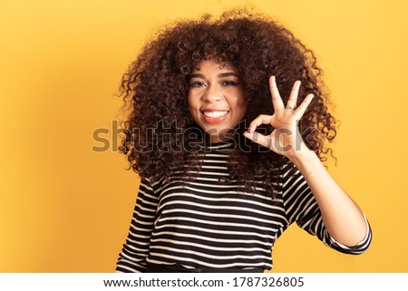 afro woman making ok sign with her hand. positive concept