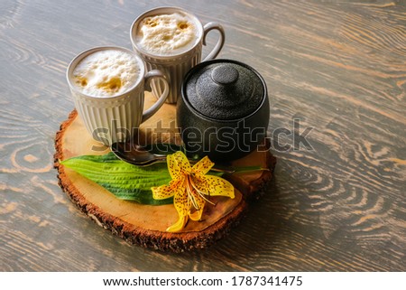 Tasty coffee served in the garden on old wooden table
