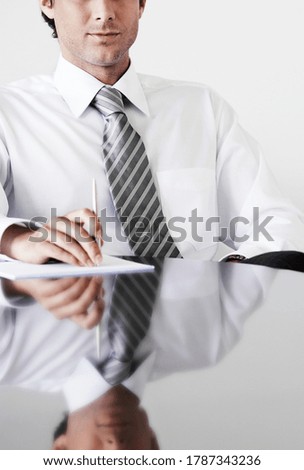 Cropped photo of businessman sitting at table in office