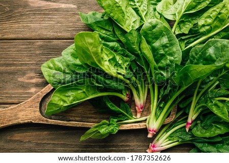Fresh spinach on wooden background Royalty-Free Stock Photo #1787352626