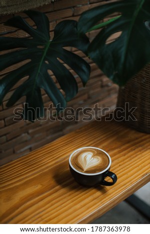 heart coffee latte art in a coffee cup 
on wood table  Royalty-Free Stock Photo #1787363978