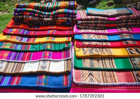 Traditional fabrics in Copacabana, Bolivia with indigenous and ethnics bright colors. Clothing stand in the outdoors with bolivian colorful textiles