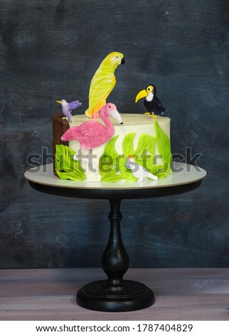 Fantastic tropical fondant cake with flamingo and a parrot