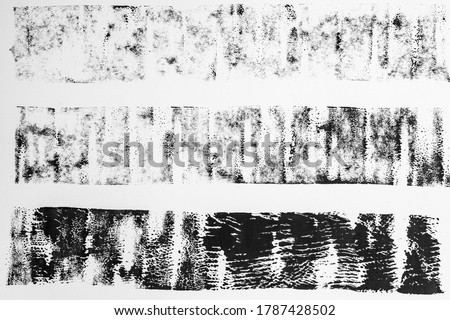 high res macro photo of black lino ink remain, linocutting paint roller texture on white paper background. Royalty-Free Stock Photo #1787428502