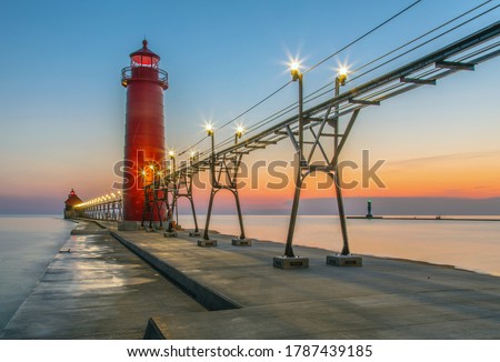View of the Grand Haven South Pierhead Inner and Outer Lighthouses at sunset; Grand Haven State Park, Lake Michigan Royalty-Free Stock Photo #1787439185