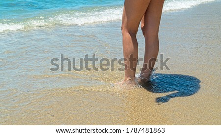 female legs in the sand	