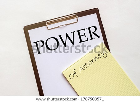 white and yellow paper with text Power Of Attorney on a white background with stationery