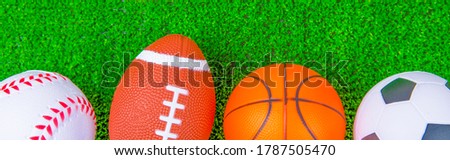 Balls for baseball, american football, basketball, soccer. lie on the green. Outdoor sports championship. Different types of games. copy space