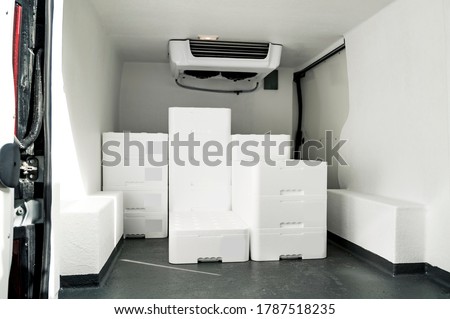 White boxes with ice and fish loaded in van for transportation Royalty-Free Stock Photo #1787518235