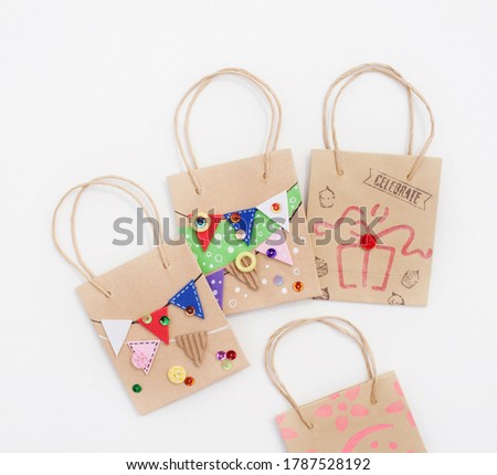bag decorated with garlands typical of birthday parties. Crafts. Present.