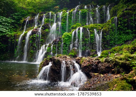 Tropical landscape. Beautiful hidden waterfall in rainforest. Adventure and travel concept. Nature background. Slow shutter speed, motion photography. Banyu Wana Amertha waterfall Bali, Indonesia