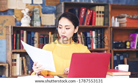 Working asian woman in the living room. Telemeeting. Video conference. Remote work. Royalty-Free Stock Photo #1787553131