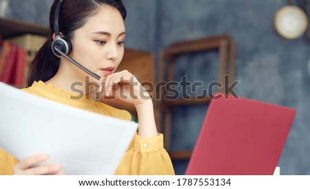 Working asian woman in the living room. Telemeeting. Video conference. Remote work. Royalty-Free Stock Photo #1787553134