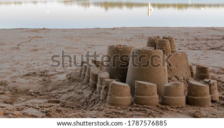 Sand castle on lake shore, a perfect landscape picture for nature magazine 