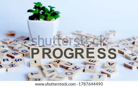 PROGRESS word letters on wooden blocks with wooden letters. BUSINESS concept.