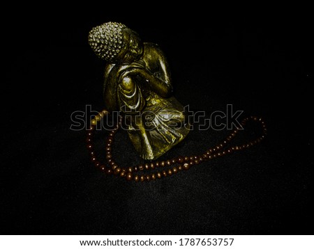golden buddha object on black background