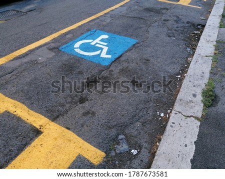 Road sign for the disabled on the asphalt of the road surface