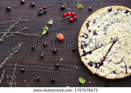 Homemade pie with berries on wooden table texture. Summer photo receipts                               