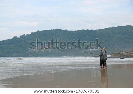 Fishermen fishing by the sea
