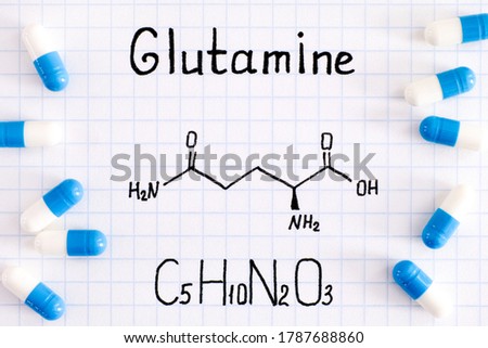Chemical formula of Glutamine with some pills. Close-up. Royalty-Free Stock Photo #1787688860