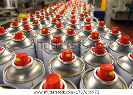 Aerosol cans in busy factory  Royalty-Free Stock Photo #1787696972