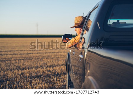 Young man in straw hat driving truck Royalty-Free Stock Photo #1787712743