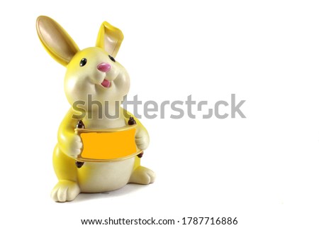 A rabbit doll standing on a white background