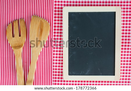 Menu blackboard with wooden spoon and fork