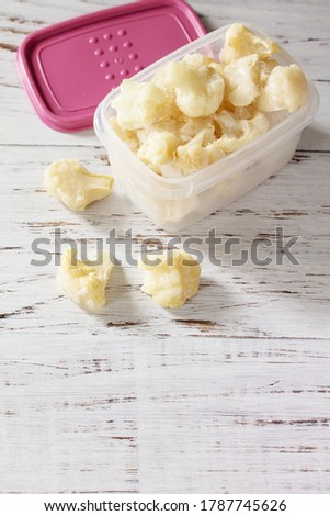 Healthy frozen food for the winter. Containers with frozen cauliflower. 