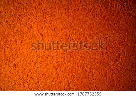 Photography image of beautiful abstract bright orange, rough cement wall background in very warm mood with fine texture. Pantone of the year color concept background banner with space for text.