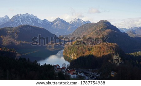 Aerial panoramic view of Alpsee Lake, Hohenschwangau castle and Bavarian Alps, Germany
