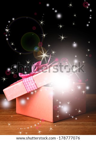 Open gift box on dark background