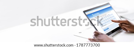 African Woman Filling Survey Poll Or Form On Laptop Computer Royalty-Free Stock Photo #1787773700