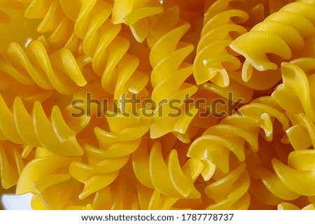 full grain spiral pasta on white background, top view. close up.