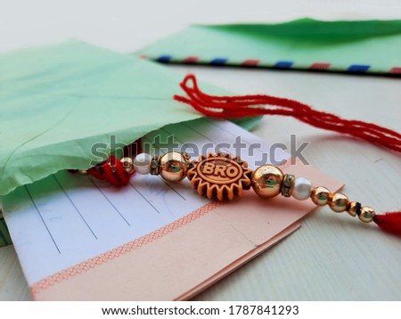 closeup of Rakhee or holy thread with message in envelope on Raksha Bandhan