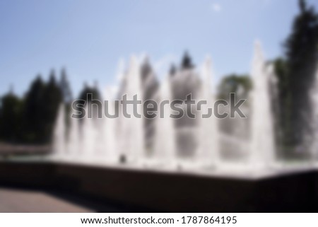 Blurred background of a fountain in the Park. Holiday destination.