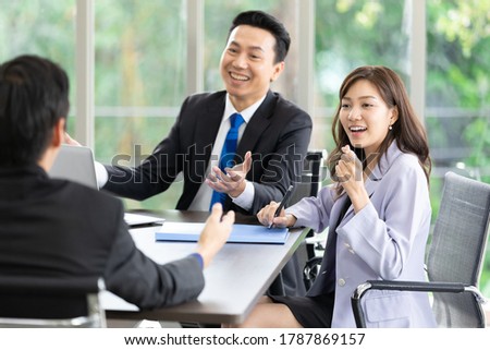 asian business team listening to co-worker explaining about work or project