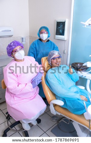 


Happy dentist with her patient showing her  new braces