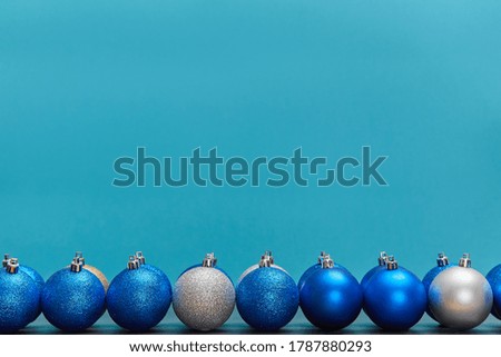 Golden blue and silver balls isolated on blue background. Copy space. New year. Christmas winter holiday concept