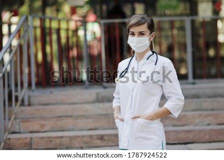 Female doctor or nurse wearing a face protective mask Covid19 healthcare concept