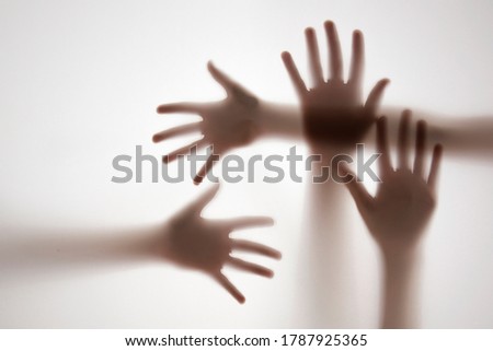 shadow of a hands behind transparent paper